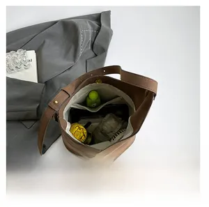 Top view of large capacity suede bucket bag showing spacious interior with daily essentials
