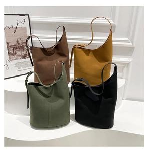 Minimalist bucket bags in brown, yellow, green, and black with adjustable straps