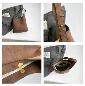Detail view of brown suede bucket bag featuring magnetic closure and adjustable strap