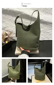Detail of dark green suede bucket bag featuring vertical stitching and adjustable strap