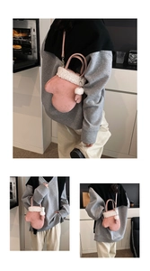 Detail of pink glove-shaped plush handbag with white faux fur trim and pompom charm