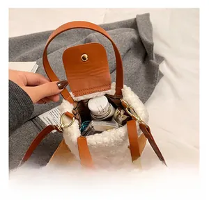 Close-up of brown leather crossbody bag with faux shearling lining showing inner capacity