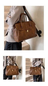 Detalle del bolso tote marrón vintage con cierre metálico dorado y textura de cuero suave