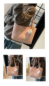 Detail of pink marble textured tote bag with adjustable strap and plush pendant decor