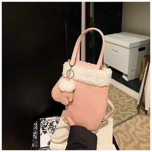 Pink glove-shaped crossbody bag with white faux fur trim and fluffy pom-pom detail