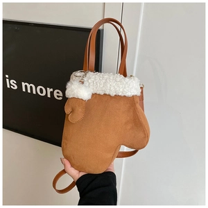 Detail of unique brown suede glove-shaped crossbody bag with soft white faux fur trim