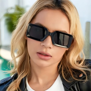 Fashionable black thick frame rectangular sunglasses with cutout temples on model