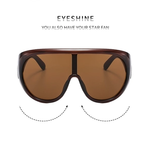 Dettaglio occhiali da sole sportivi oversize con lenti marroni e marchio EYESHINE