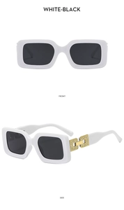 Detail of white rectangular sunglasses with black lenses and gold chain cut-out temples