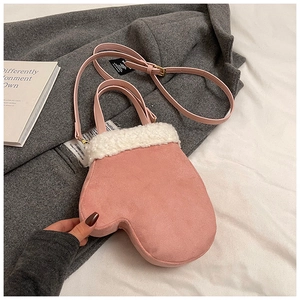 Detail of pink mitten-shaped crossbody bag featuring white faux shearling trim and strap