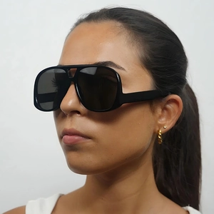 Chic black oversized pilot sunglasses with thick frames and a minimalist street style