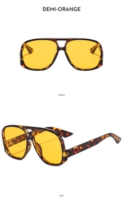 Detail view of aviator sunglasses with demi-patterned frames and orange lenses