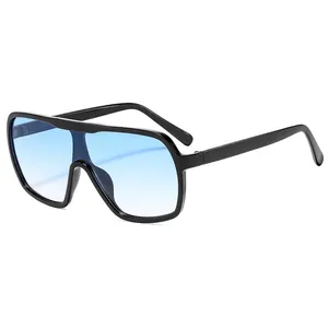 Fashion oversized black frame sunglasses with blue gradient lenses for women outdoors
