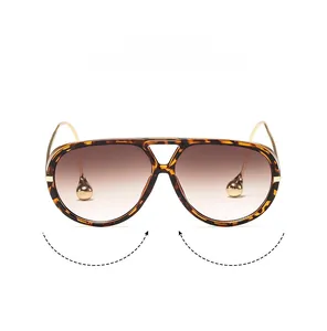 Detail of tortoise pilot sunglasses with gradient lenses and gold drop-shaped temple tips