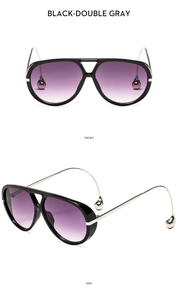 Detail of pilot sunglasses with purple gradient lenses and silver droplet-shaped tips