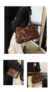 Detail view of stylish dark brown tote bag with multi-pocket design and dog charm