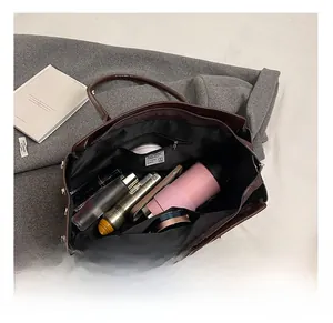 Interior view of large tote bag showing spacious compartments and zipper pockets