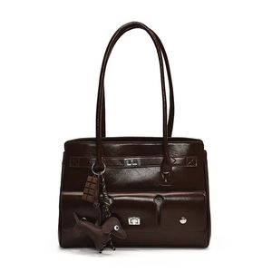 Close-up of deep brown glossy leather handbag with silver twist locks and dog charms
