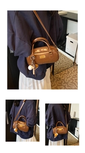 Brown patent leather Boston handbag with handle and shoulder strap for women daily commuting.