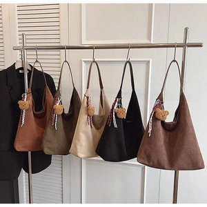 Detail view of large capacity hobo bags in five colors with cute bear charms attached
