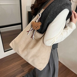 Minimalist large khaki tote bag with plush bear charm and brown leather straps