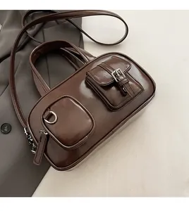 Close-up of vintage brown glossy bowling bag with stylish pockets and metallic buckles