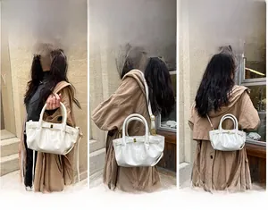 Three-way carry demonstration of cream pleated dumpling bag with golden buckle detail