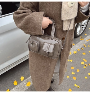 Detailed view of olive brown retro crossbody bag with dual functional pockets and leather texture