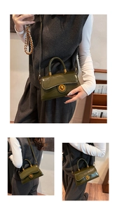 Detail view of olive green patent leather handbag with a golden rotating lock