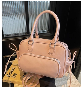 Close-up of pink PU leather bowling bag showing zipper pocket and bow details