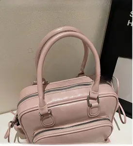 Detailed view of pink PU leather bowling bag showing sturdy handles and metal zipper finish