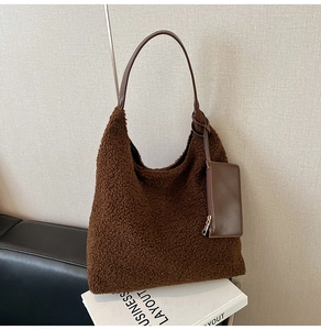Detail of dark brown faux shearling tote bag with matching leather coin purse and strap