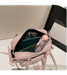 Top view showing the spacious interior of a light pink bowling bag with daily essentials