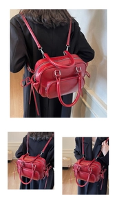 Macro view of adjustable red leather backpack with side bows and polished metal zippers