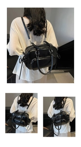 Detail view of black PU leather multi-functional backpack and tote bag with side ties