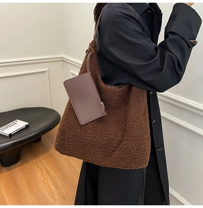 Detail of teddy fleece hobo tote with a leather coin pouch and matching shoulder strap