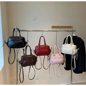 Detailed row of vintage style Boston bags in five colors with adjustable shoulder straps