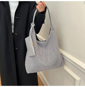 Detail of grey plush faux fur tote bag with matching detachable zipper pouch accessory