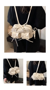 Detail of cream multi-pocket shoulder bag featuring 3D pockets and bow drawstring accents