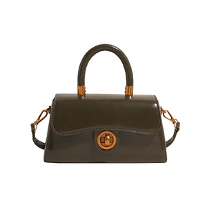 Minimalist deep green glossy leather tote bag with gold hardware and trapezoid design