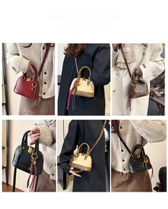 Detailed view of vintage shell-shaped handbag in multiple colors with heart charms
