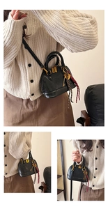 Detail of a black mini shell handbag with golden zipper and rope key pendant charm