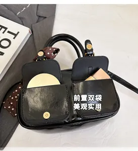 Glossy black leather bowling bag with front pockets for lipstick and cosmetics