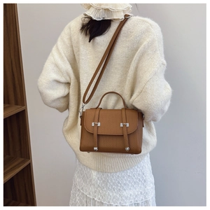 Brown PU leather crossbody bag with vertical texture and adjustable shoulder strap