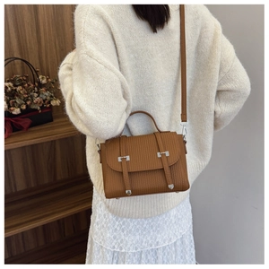 Brown vintage handbag with vertical embossing shown in a cozy lifestyle setting
