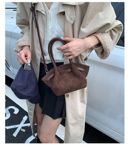 Brown suede basket bag shown with a beige trench coat and casual urban outfit details