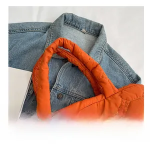 Detail of comfortable quilted handle and orange padded fabric on minimalist tote bag
