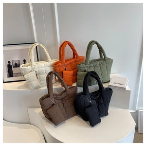 Quilted cloud tote bags in various colors displayed with matching small zipper pouches