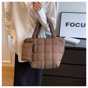 Detailed view of brown quilted tote bag with a matching small pouch for daily commute