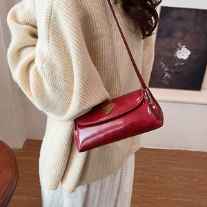 Retro red oil wax leather pillow bag for women with gold triangle logo on crossbody strap